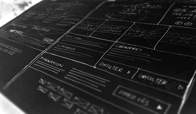 Hand drawn website wireframe sketches on a dark blue background
